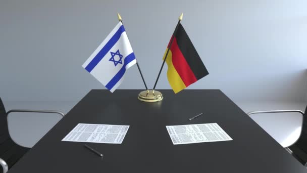 Drapeaux d'Israël et d'Allemagne et papiers sur la table. Négociations et signature d'un accord international. Animation 3D conceptuelle — Video