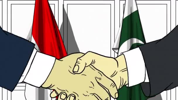 Бизнесмены или политики пожимают руку флагу Индонезии и Пакистана. Официальная встреча или сотрудничество по анимации мультфильмов — стоковое видео