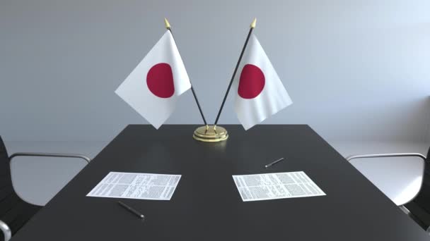 Fahnen Japans und Papiere auf dem Tisch. Verhandlungen und Unterzeichnung eines Abkommens. konzeptionelle 3D-Animation — Stockvideo