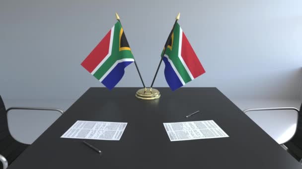 Прапори Південної Африки і документи на столі. Переговорів і підписання договору. Концептуальні 3d анімація — стокове відео