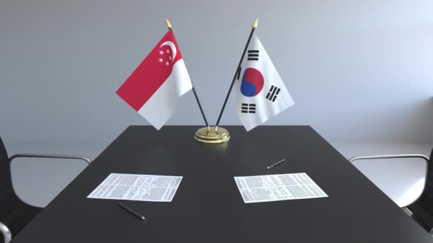 Flaggen von Singapore und Südkorea und Papiere auf dem Tisch. Verhandlungen und die Unterzeichnung eines internationalen Abkommens. konzeptionelle 3D-Animation — Stockvideo
