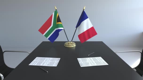 Bandiere del Sudafrica e della Francia e documenti sul tavolo. Negoziati e firma di un accordo internazionale. Animazione 3D concettuale — Video Stock