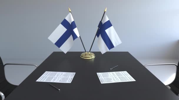 Finnland-Flaggen und Papiere auf dem Tisch. Verhandlungen und Unterzeichnung eines Abkommens. konzeptionelle 3D-Animation — Stockvideo