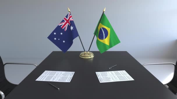 Flaggen Australiens und Brasiliens und Papiere auf dem Tisch. Verhandlungen und die Unterzeichnung eines internationalen Abkommens. konzeptionelle 3D-Animation — Stockvideo