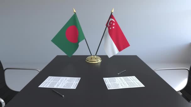 Banderas de Bangladesh y Singapur y documentos sobre la mesa. Negociaciones y firma de un acuerdo internacional. Animación 3D conceptual — Vídeo de stock
