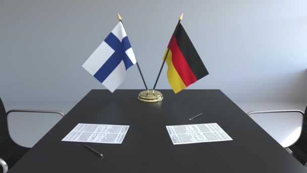 Bandiere della Finlandia e della Germania e documenti sul tavolo. Negoziati e firma di un accordo internazionale. Animazione 3D concettuale — Video Stock