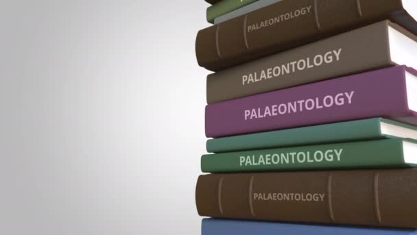 PALAEONTOLOGY title on the stack of books, conceptual loopable 3D animation — Stock Video