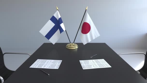 Banderas de Finlandia y Japón y papeles sobre la mesa. Negociaciones y firma de un acuerdo internacional. Animación 3D conceptual — Vídeos de Stock