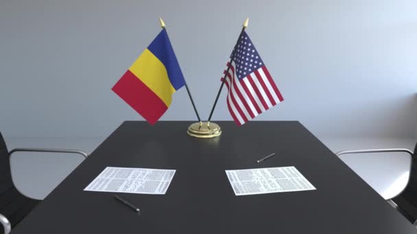 Banderas de Rumania y los Estados Unidos de América y documentos sobre la mesa. Negociaciones y firma de un acuerdo internacional. Animación 3D conceptual — Vídeo de stock