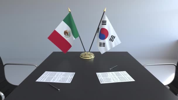 Flaggen Mexikos und Südkoreas und Papiere auf dem Tisch. Verhandlungen und die Unterzeichnung eines internationalen Abkommens. konzeptionelle 3D-Animation — Stockvideo