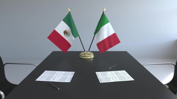 Lijst van vlaggen van Mexico en Italië en papieren op de tafel. Onderhandelingen en ondertekening van een internationale overeenkomst. Conceptuele 3d animatie — Stockvideo