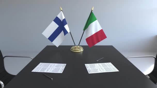 Flaggen von Finnland und Italien und Papiere auf dem Tisch. Verhandlungen und die Unterzeichnung eines internationalen Abkommens. konzeptionelle 3D-Animation — Stockvideo
