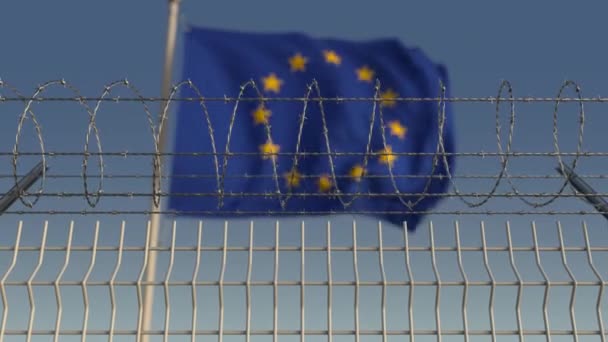 Defocused melambaikan bendera Uni Eropa Uni Eropa di belakang pagar kawat berduri. Animasi 3D dapat dilepas — Stok Video