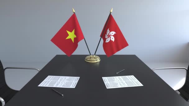 Banderas de Vietnam y Hong Kong y papeles sobre la mesa. Negociaciones y firma de un acuerdo internacional. Animación 3D conceptual — Vídeos de Stock