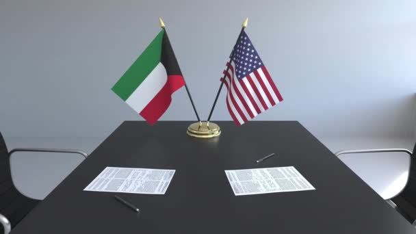 Banderas de Kuwait y Estados Unidos y documentos sobre la mesa. Negociaciones y firma de un acuerdo internacional. Animación 3D conceptual — Vídeo de stock