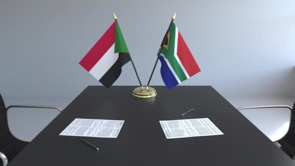 Bandiere del Sudan e del Sudafrica e documenti sul tavolo. Negoziati e firma di un accordo internazionale. Animazione 3D concettuale — Video Stock