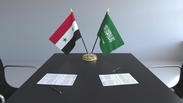 Zászlók, Szíria és Szaúd-Arábia és papírok az asztalon. A tárgyalások és a nemzetközi megállapodást. Fogalmi 3d animáció — Stock videók