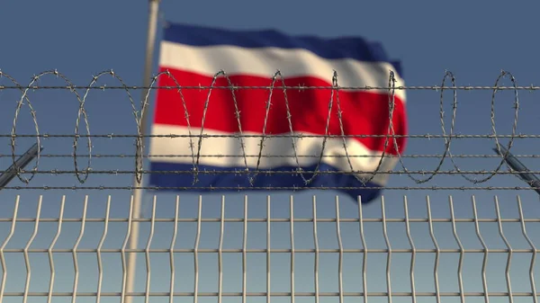 Defocused waving flag of Costa rica behind barbed wire fence. 3D rendering — Stock Photo, Image