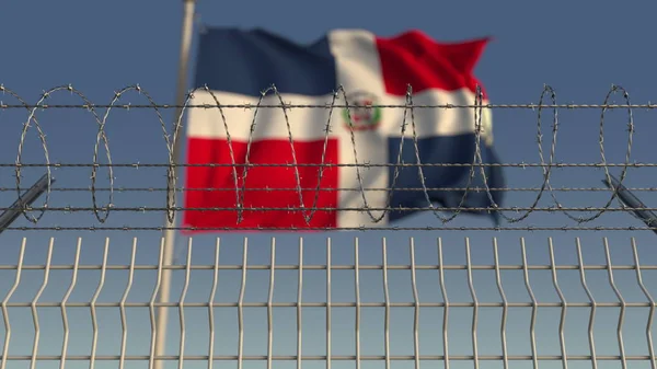 Bandeira acenando borrada da República Dominicana atrás da cerca de arame farpado. Renderização 3D — Fotografia de Stock