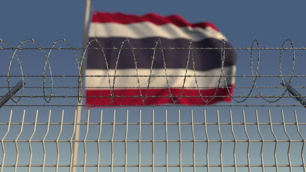 Blurred waving flag of Thailand behind barbed wire fence. 3D rendering — Stock Photo, Image