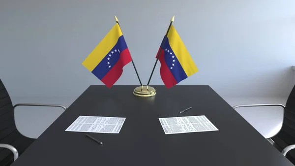 Banderas de Venezuela y papeles sobre la mesa. Negociaciones y firma de un acuerdo. Renderizado 3D conceptual — Foto de Stock