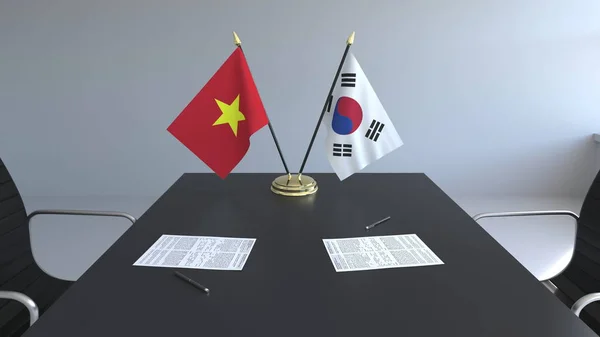 Bandeiras do Vietname e da Coreia do Sul e documentos sobre a mesa. Negociações e assinatura de um acordo internacional. Renderização 3D conceitual — Fotografia de Stock