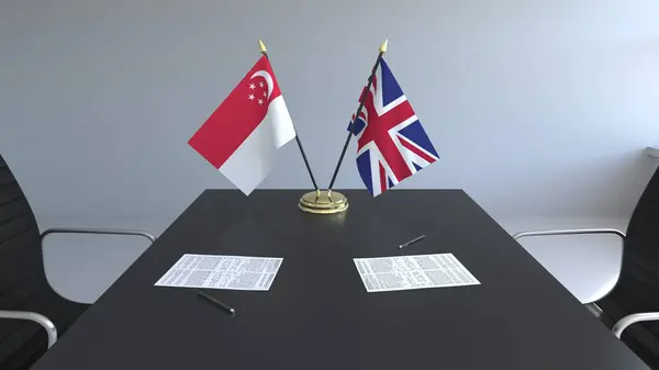 Flaggor av Singapore och Storbritannien och papper på bordet. Förhandlingarna och underteckna internationella avtal. Konceptuell 3d-rendering — Stockfoto