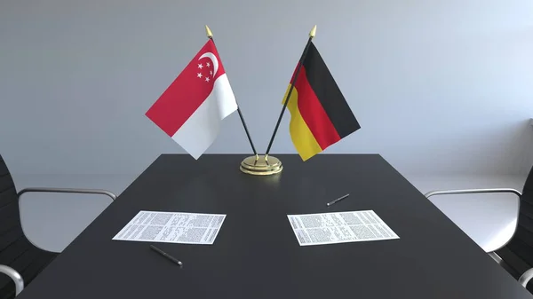 Bandeiras de Singapura e da Alemanha e papéis na mesa. Negociações e assinatura de um acordo internacional. Renderização 3D conceitual — Fotografia de Stock