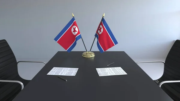 Bandeiras da Coreia do Norte e papéis na mesa. Negociações e assinatura de um acordo. Renderização 3D conceitual — Fotografia de Stock