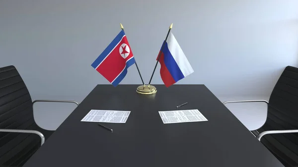 Прапори Північної Кореї та Росії і документи на столі. Переговорів і підписання міжнародного договору. Концептуальна 3d-рендерінг — стокове фото