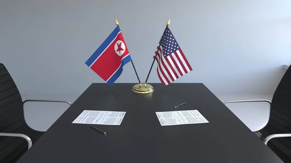Vlajky Severní Koreje a Spojených států a papíry na stole. Jednání a podepisování mezinárodní dohody. Konceptuální 3d vykreslování — Stock fotografie