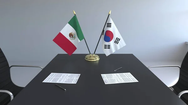 Флаги Мексики и Южной Кореи и бумаги на столе. Переговоры и подписание международного соглашения. Концептуальная 3D рендеринг — стоковое фото