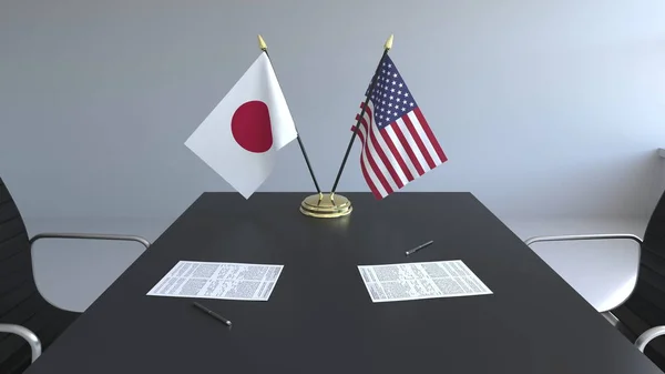 Σημαίες της Ιαπωνίας και Ηνωμένων Πολιτειών της Αμερικής και χαρτιά στο τραπέζι. Οι διαπραγματεύσεις και η υπογραφή μιας διεθνούς συμφωνίας. Εννοιολογική 3d rendering — Φωτογραφία Αρχείου