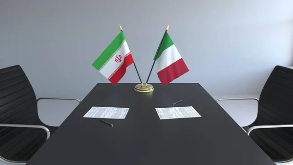 Banderas de Irán e Italia documentos sobre la mesa. Negociaciones y firma de un acuerdo internacional. Renderizado 3D conceptual —  Fotos de Stock