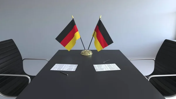 Bendera Jerman dan kertas di atas meja. Negosiasi dan penandatanganan perjanjian. Pencitraan 3D konseptual — Stok Foto