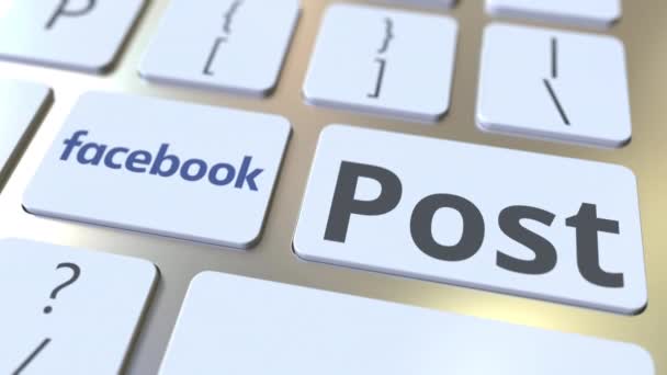 Logo společnosti Facebook a post text na klávesách počítačové klávesnice, redakční konceptuální animace — Stock video