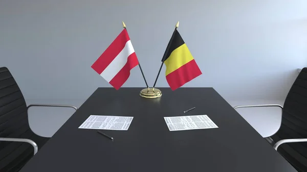 Σημαίες της Αυστρίας και του Βελγίου και χαρτιά στο τραπέζι. Οι διαπραγματεύσεις και η υπογραφή μιας διεθνούς συμφωνίας. Εννοιολογική 3d rendering — Φωτογραφία Αρχείου