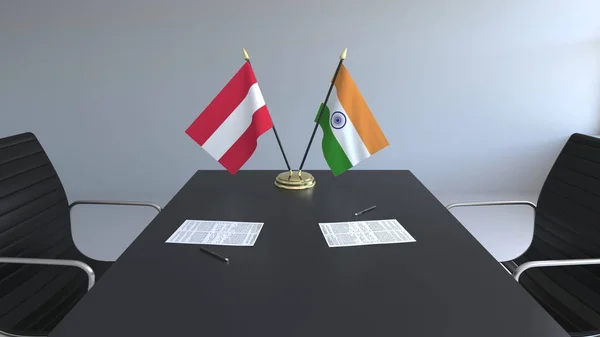 Flaggor av Österrike och Indien och papper på bordet. Förhandlingarna och underteckna internationella avtal. Konceptuell 3d-rendering — Stockfoto