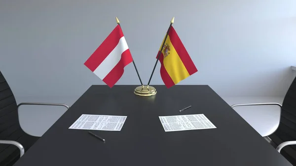 Bandiere dell'Austria e della Spagna e documenti sul tavolo. Negoziati e firma di un accordo internazionale. Rendering 3D concettuale — Foto Stock