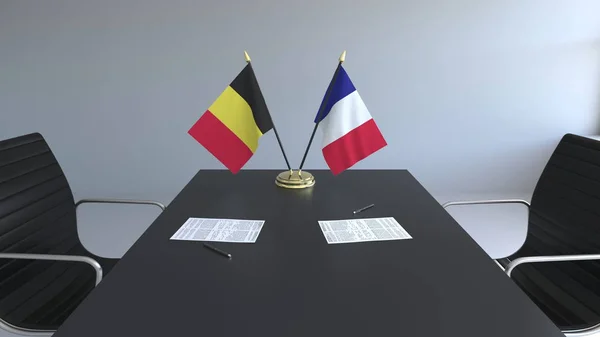 Flags of Belgium and France and papers on the table. Negotiations and signing an international agreement. Conceptual 3D rendering — Stock Photo, Image