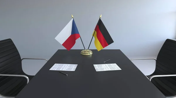 Vlajky České republiky a Německa a papíry na stole. Jednání a podepisování mezinárodní dohody. Konceptuální 3d vykreslování — Stock fotografie