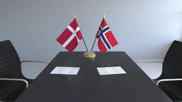 Flaggor av Danmark och Norge och papper på bordet. Förhandlingarna och underteckna internationella avtal. Konceptuell 3d-rendering — Stockfoto