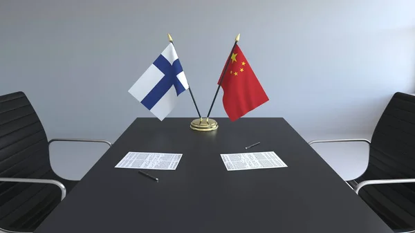 Flaggen von Finnland und China und Papiere auf dem Tisch. Verhandlungen und die Unterzeichnung eines internationalen Abkommens. konzeptionelles 3D-Rendering — Stockfoto