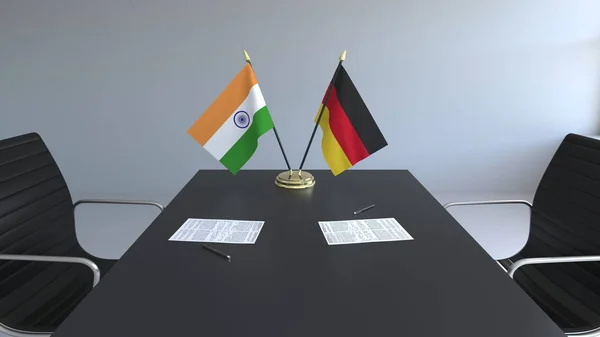 Flaggor av Indien och Tyskland och papper på bordet. Förhandlingarna och underteckna internationella avtal. Konceptuell 3d-rendering — Stockfoto