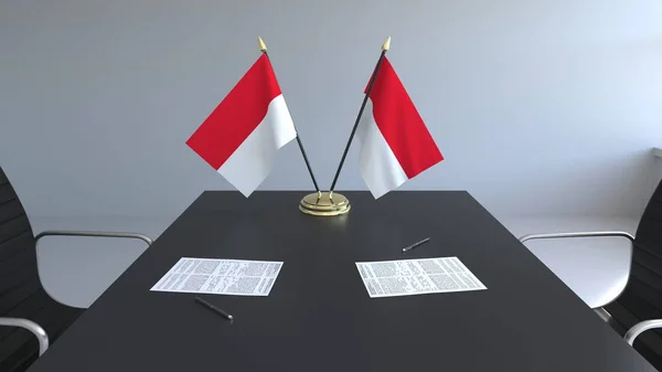 Flaggen Indonesiens und Papiere auf dem Tisch. Verhandlungen und Unterzeichnung eines Abkommens. konzeptionelles 3D-Rendering — Stockfoto