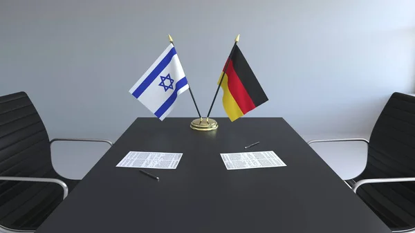 Bandeiras de Israel e da Alemanha e papéis na mesa. Negociações e assinatura de um acordo internacional. Renderização 3D conceitual — Fotografia de Stock