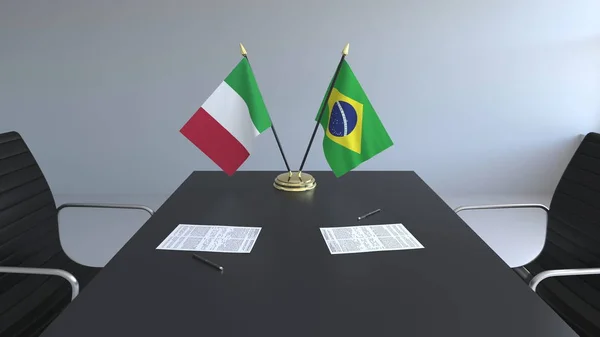 Флаги Италии и Бразилии и бумаги на столе. Переговоры и подписание международного соглашения. Концептуальная 3D рендеринг — стоковое фото