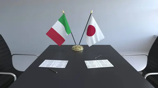 イタリアと日本とテーブルの上の論文のフラグです。交渉と国際協定に署名します。概念 3 d レンダリング — ストック写真