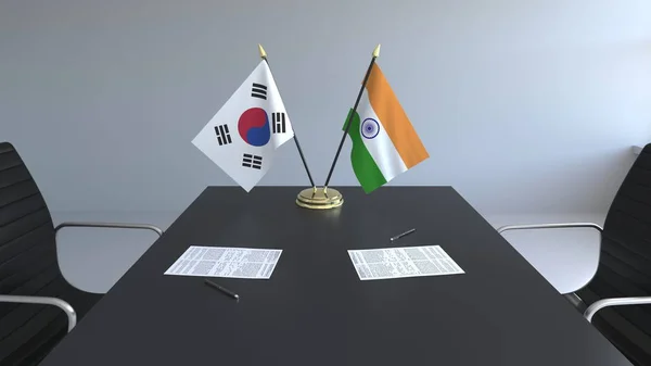 Bandeiras da Coreia do Sul e Índia e papéis na mesa. Negociações e assinatura de um acordo internacional. Renderização 3D conceitual — Fotografia de Stock