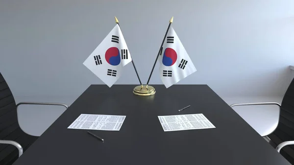 Bandeiras da Coreia do Sul e papéis na mesa. Negociações e assinatura de um acordo. Renderização 3D conceitual — Fotografia de Stock